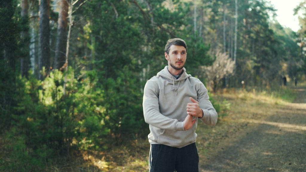 Man stretching outdoors in a forest setting