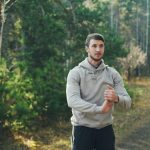 Man stretching outdoors in a forest setting