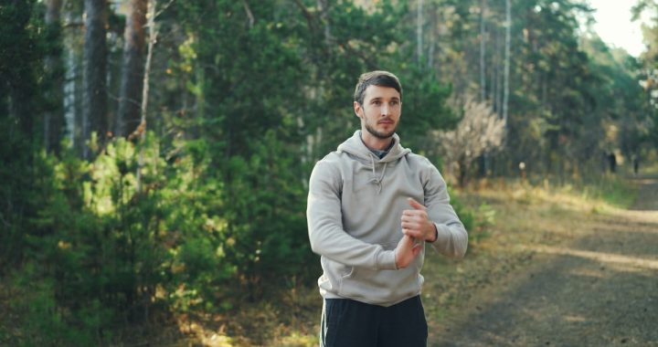 Man stretching outdoors in a forest setting